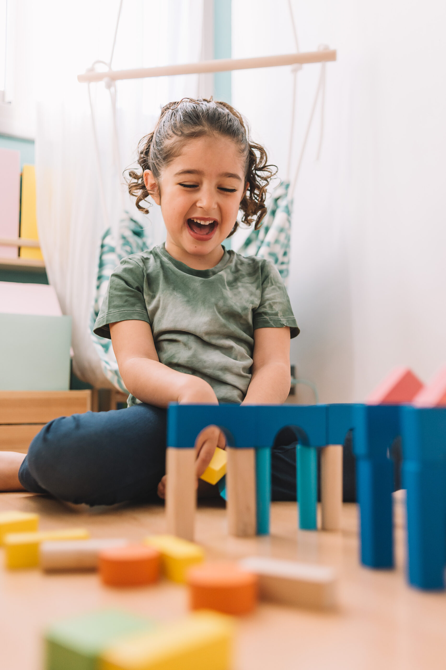 girl plays happy to build with wooden blocks